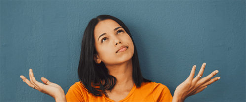 A woman with arms raised questioning budget
